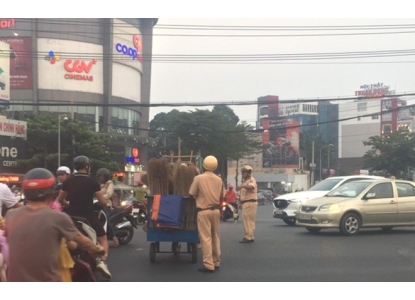 Xúc động hình ảnh CSGT giúp người mù đẩy xe bán chổi qua đường